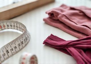 Measuring tape and fabric swatches arranged neatly for a perfect fit clinic